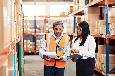 Buy stock photo Shot of a mature man and woman working together in a warehouse