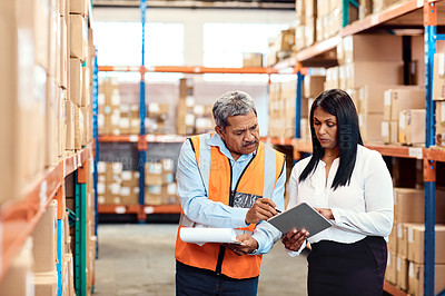 Buy stock photo Shot of a mature man and woman working together in a warehouse