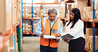 Buy stock photo Shot of a mature man and woman working together in a warehouse