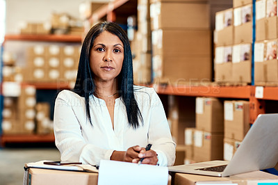 Buy stock photo Portrait of a mature factory manager working on a laptop in a warehouse