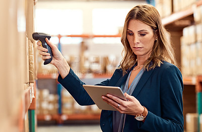 Buy stock photo Shot of a young factory manager using a barcode reader and digital tablet in a warehouse