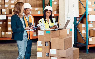 Buy stock photo Shot of a group of factory workers having a discussion in a warehouse