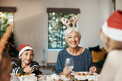 Buy stock photo Cropped shot of a family having lunch together at a table during Christmas time