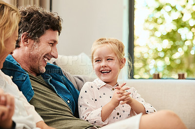 Buy stock photo Shot of a happy family relaxing together on the sofa at home