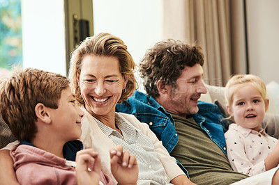 Buy stock photo Shot of a happy family relaxing together on the sofa at home