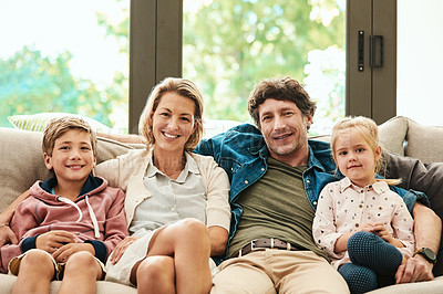Buy stock photo Shot of a happy family relaxing together on the sofa at home