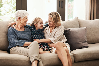 Buy stock photo Shot of a happy senior woman relaxing on the sofa with her daughter and granddaughter at home