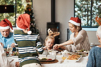 Buy stock photo Cropped shot of a family having lunch together at a table during Christmas time