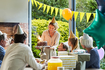 Buy stock photo Shot of a happy family celebrating a birthday at home in the garden