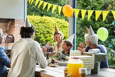 Buy stock photo Shot of a happy family celebrating a birthday at home in the garden