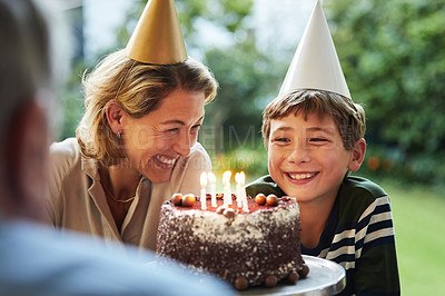 Buy stock photo Shot of a happy family celebrating a birthday at home in the garden