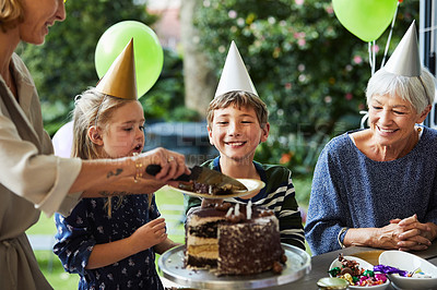 Buy stock photo Shot of a happy family celebrating a birthday at home in the garden