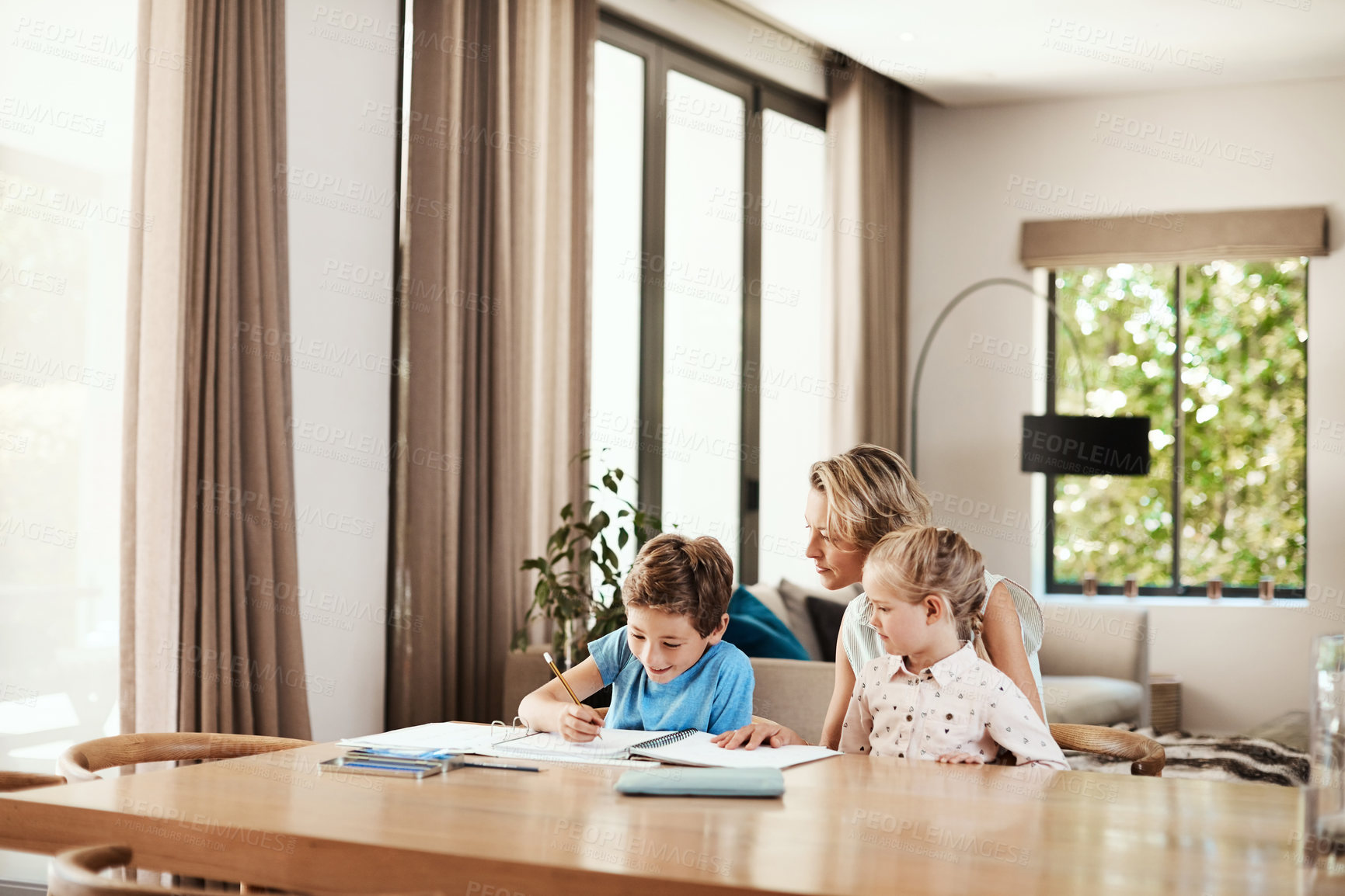 Buy stock photo Learning, child and family with help for homework, writing activity and academic support in home. Sibling, mom and happy boy with book for literacy task, education assistance and language development