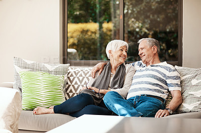 Buy stock photo Shot of a happy senior couple relaxing together on a sofa outside at home