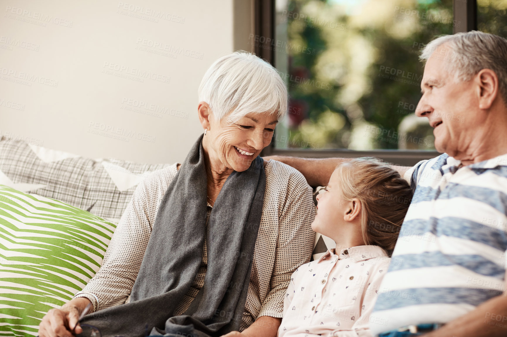 Buy stock photo Happy, laugh and grandparents on patio with child for bonding, relax and childcare on weekend. Family, generations and girl with grandma, grandpa and smile for relationship, connection and love