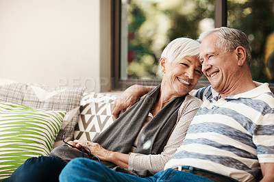 Buy stock photo Shot of a happy senior couple relaxing together on a sofa outside at home