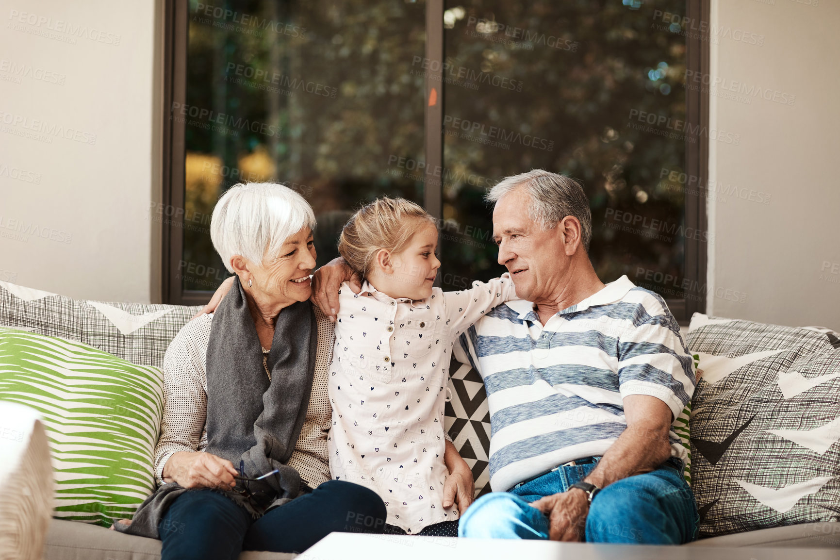 Buy stock photo Happy, hug and grandparents on patio with child for bonding, relax and babysit on weekend. Family, generations and girl with grandma, grandpa and embrace for relationship, connection and love