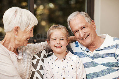 Buy stock photo Shot of an adorable little girl spending quality time with her grandmother and grandfather outside at home