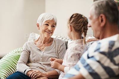 Buy stock photo Shot of an adorable little girl spending quality time with her grandmother and grandfather outside at home