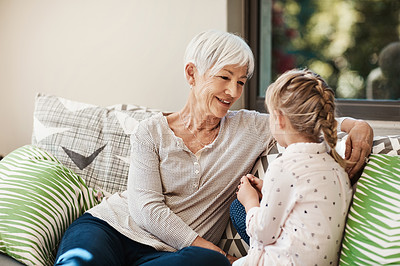 Buy stock photo Shot of a senior woman and her granddaughter spending quality time outside at home
