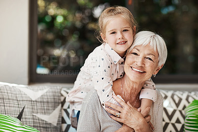 Buy stock photo Shot of a senior woman and her granddaughter playing together outside at home