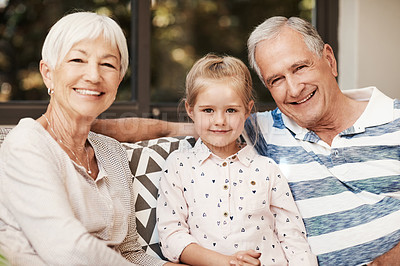 Buy stock photo Shot of an adorable little girl spending quality time with her grandmother and grandfather outside at home