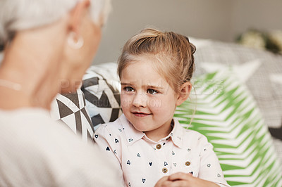 Buy stock photo Shot of a senior woman and her granddaughter spending quality time outside at home