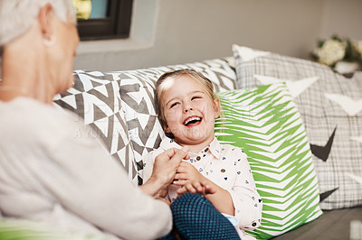 Buy stock photo Shot of a senior woman and her granddaughter spending quality time outside at home
