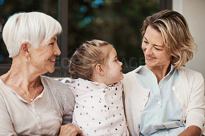 Buy stock photo Shot of a happy senior woman spending quality time with her daughter and granddaughter at home