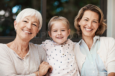 Buy stock photo Shot of a happy senior woman spending quality time with her daughter and granddaughter at home