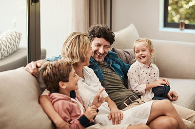 Buy stock photo Shot of a happy family relaxing together on the sofa at home
