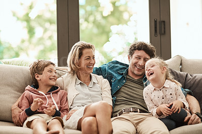 Buy stock photo Shot of a happy family relaxing together on the sofa at home