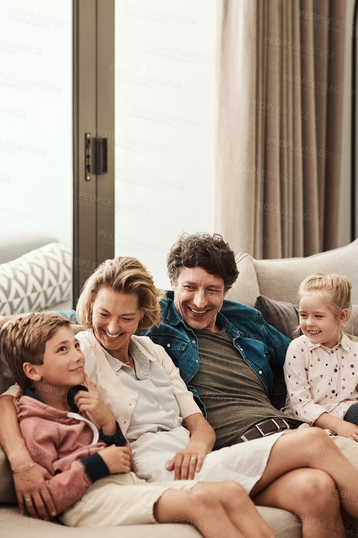 Buy stock photo Shot of a happy family relaxing together on the sofa at home