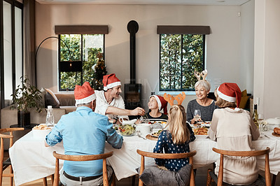 Buy stock photo Cropped shot of a family having lunch together at a table during Christmas time