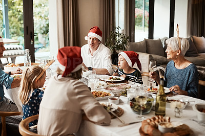Buy stock photo Cropped shot of a family having lunch together at a table during Christmas time
