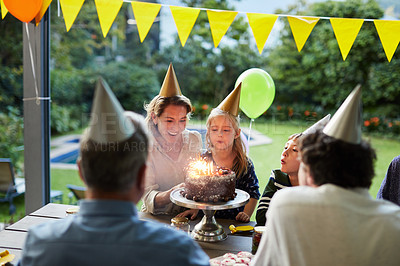 Buy stock photo Shot of a happy family celebrating a birthday at home in the garden