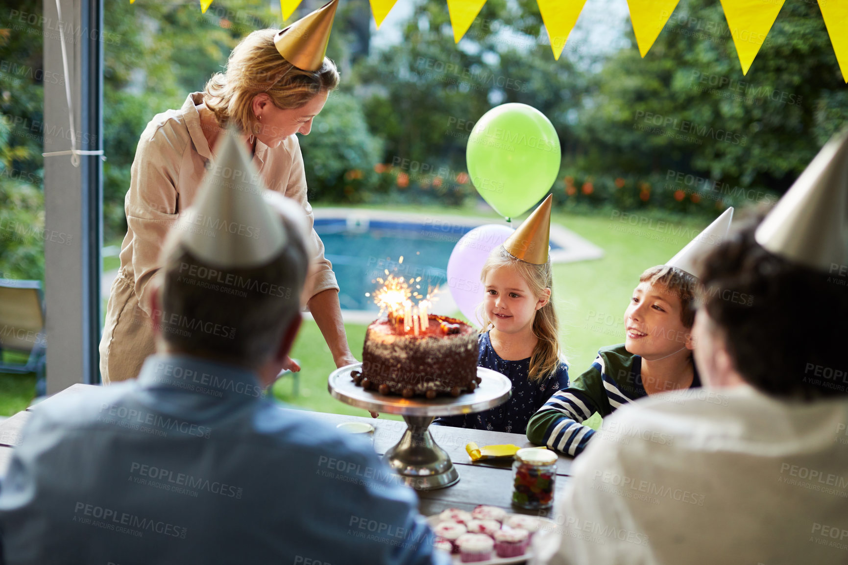 Buy stock photo Family, birthday party and children with cake, home and laughing with mother on break or connection. Group, bonding and celebration with chocolate dessert, outdoor and happy woman with kids on event