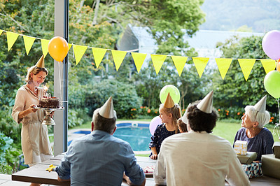Buy stock photo Shot of a happy family celebrating a birthday at home in the garden