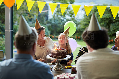 Buy stock photo Shot of a happy family celebrating a birthday at home in the garden