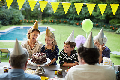 Buy stock photo Shot of a happy family celebrating a birthday at home in the garden