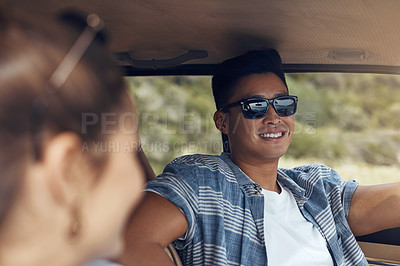 Buy stock photo Shot of a happy young couple going on a road trip together