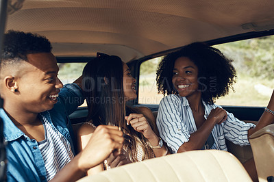 Buy stock photo Shot of a group of happy young friends going on a road trip together