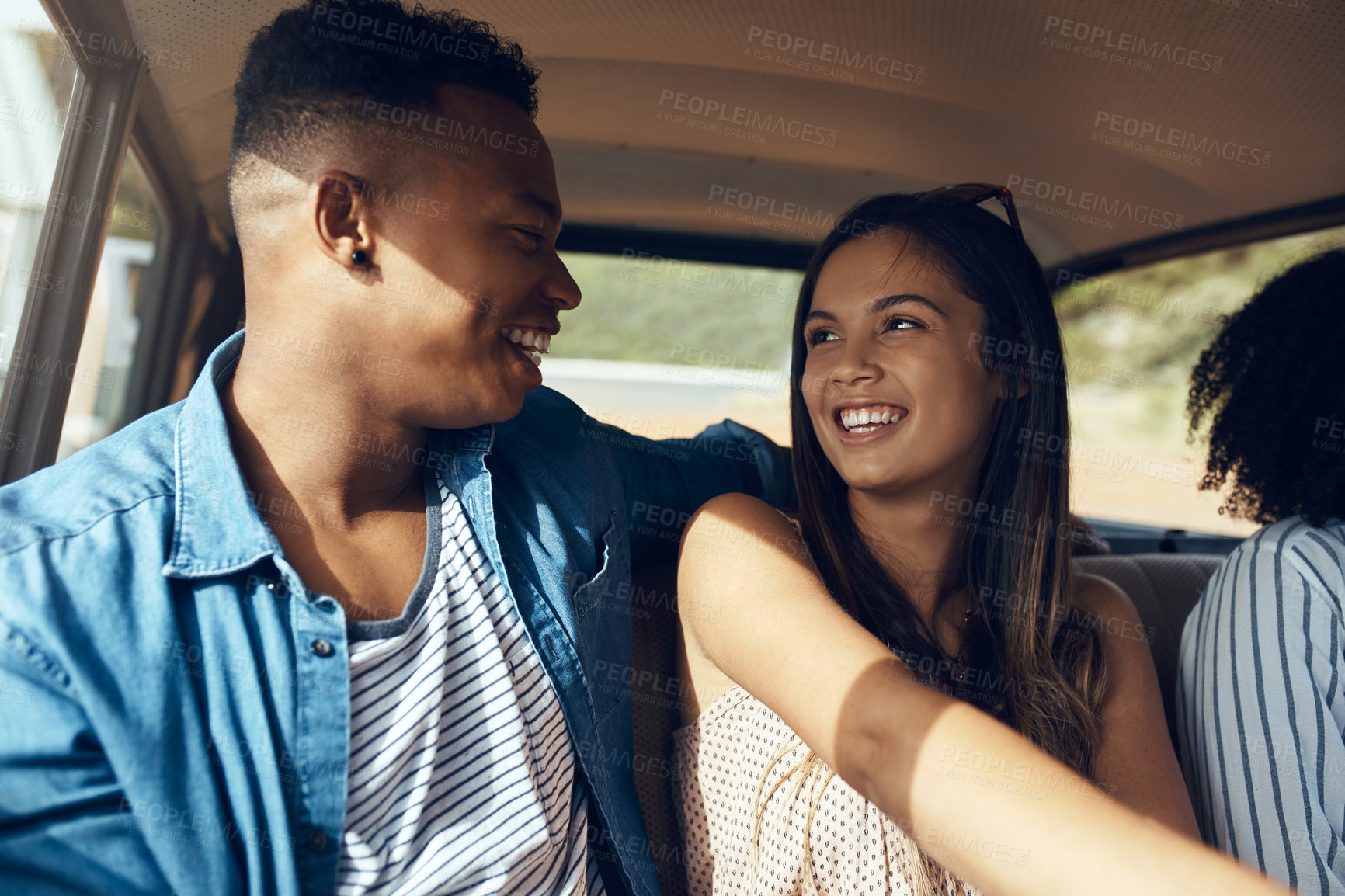 Buy stock photo Shot of a happy young couple going on a road trip with friends
