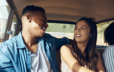 Buy stock photo Shot of a happy young couple going on a road trip with friends