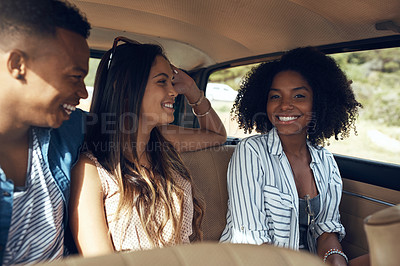 Buy stock photo Shot of a group of happy young friends going on a road trip together