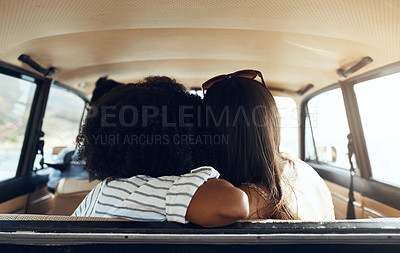 Buy stock photo Rearview shot of two young friends going on a road trip together