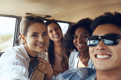 Buy stock photo Shot of a group of happy young friends going on a road trip together