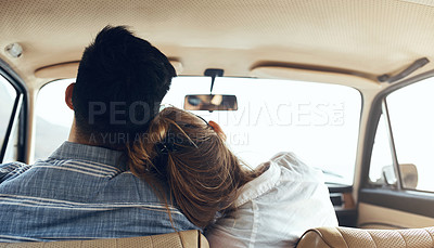 Buy stock photo Rearview shot of a happy young couple going on a road trip together