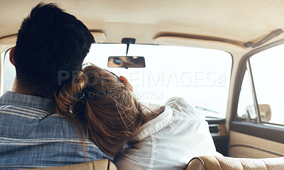 Buy stock photo Rearview shot of a happy young couple going on a road trip together