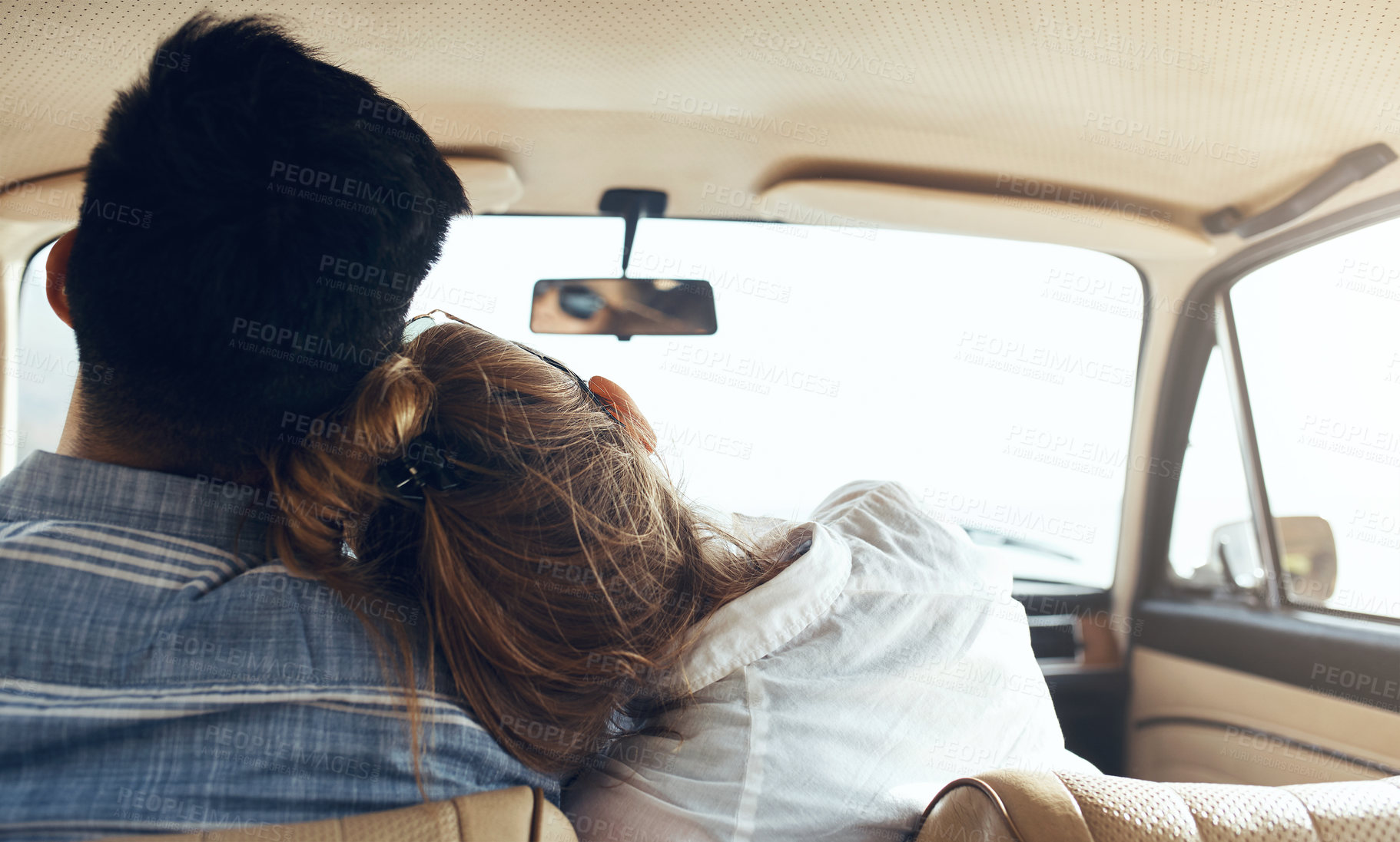 Buy stock photo Rearview shot of a happy young couple going on a road trip together